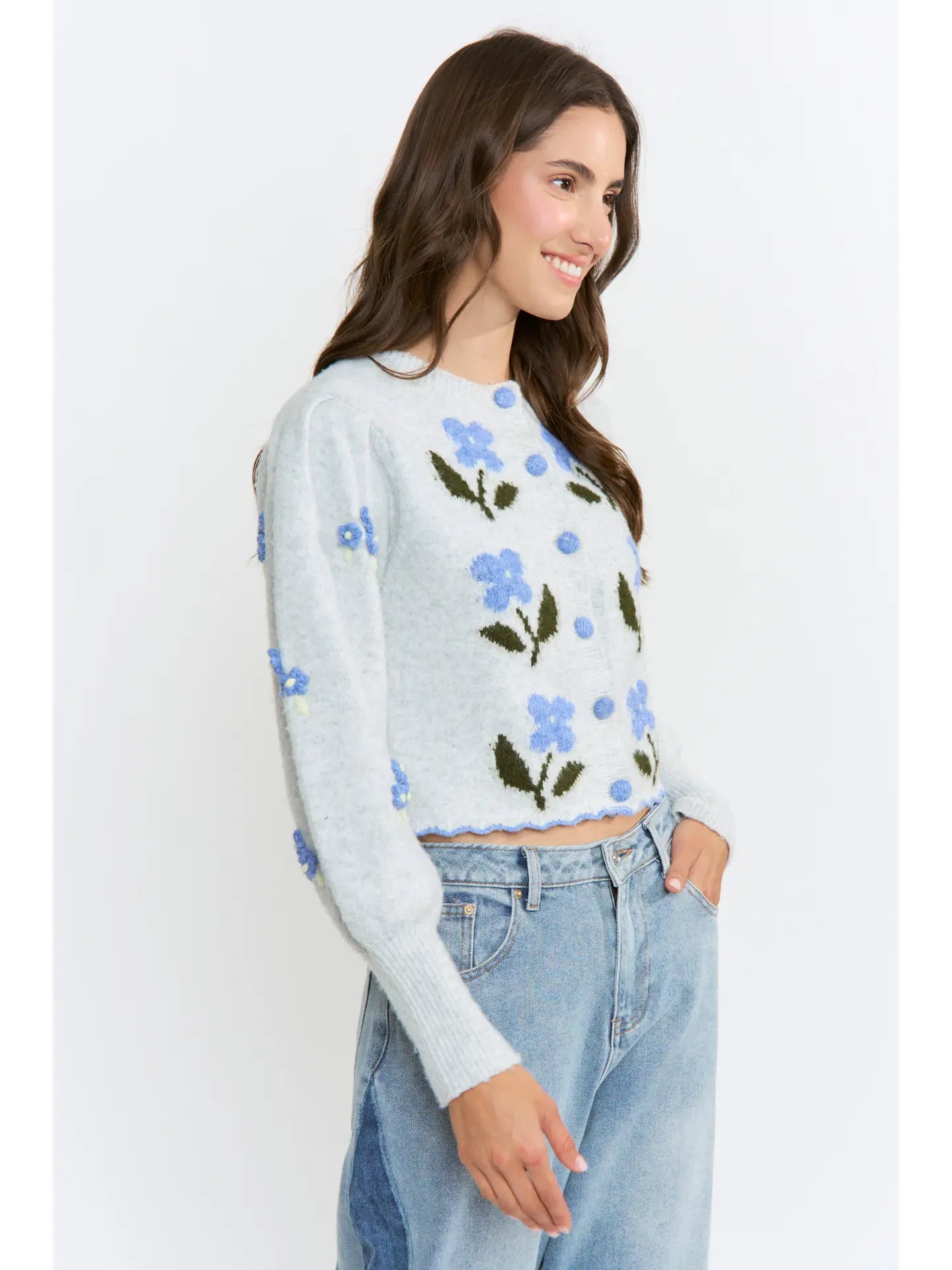 The Amelie Floral Cardigan in light grey with delicate blue floral embroidery and green stem details.
