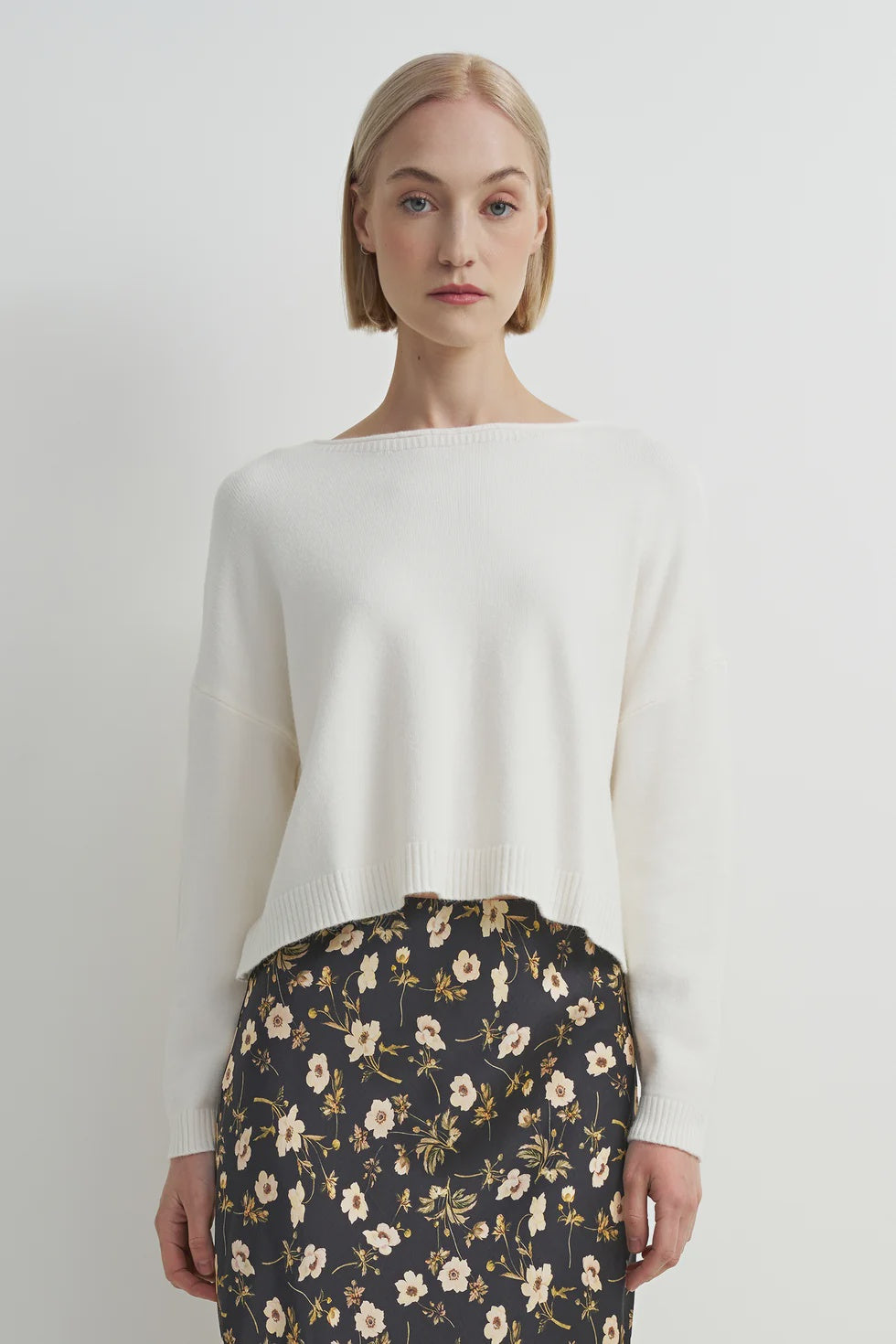 Soft cream crewneck sweater with a relaxed fit, cozy knit texture, and clean, classic silhouette.
