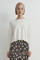 Soft cream crewneck sweater with a relaxed fit, cozy knit texture, and clean, classic silhouette.
