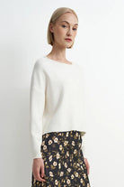 Soft cream crewneck sweater with a relaxed fit, cozy knit texture, and clean, classic silhouette.
