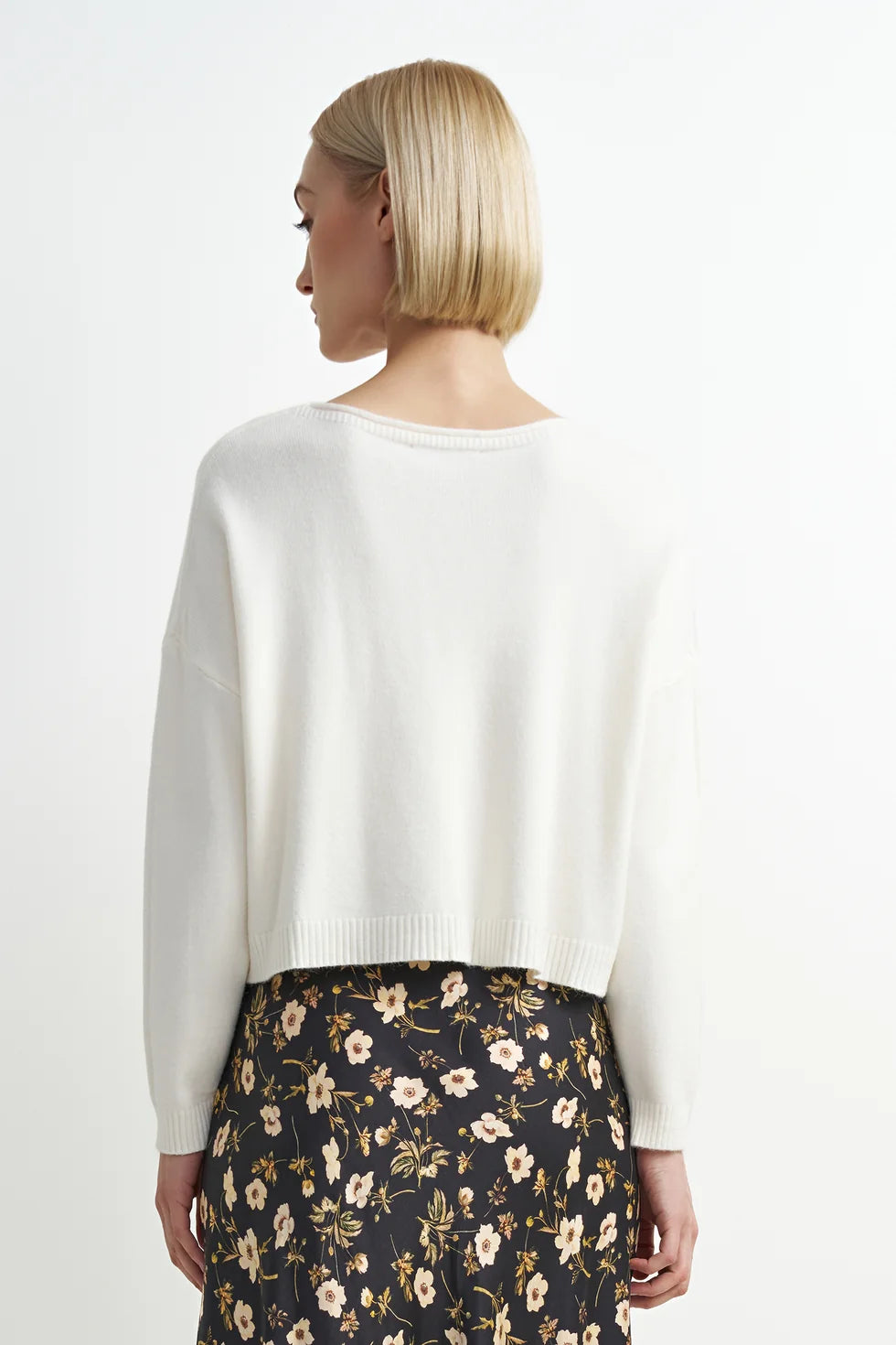 Soft cream crewneck sweater with a relaxed fit, cozy knit texture, and clean, classic silhouette.
