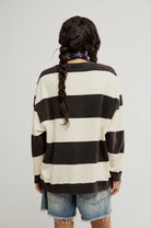 woman wearing black and white striped oversized crewneck