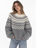 The Brielle Knit Pullover is your new go-to for cozy days. Designed in a soft grey knit with a contrasting cream Nordic-inspired pattern, it features a relaxed fit, classic crew neckline, and easy long sleeves. The perfect statement knit to throw on with denim for an effortlessly put-together fall and winter look.