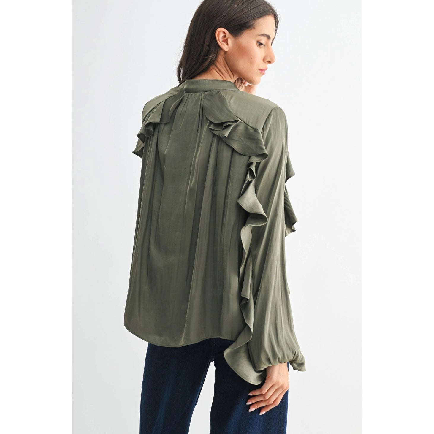 The Juliette Ruffle Blouse in olive green, featuring delicate ruffle detailing and a soft, silky finish.
