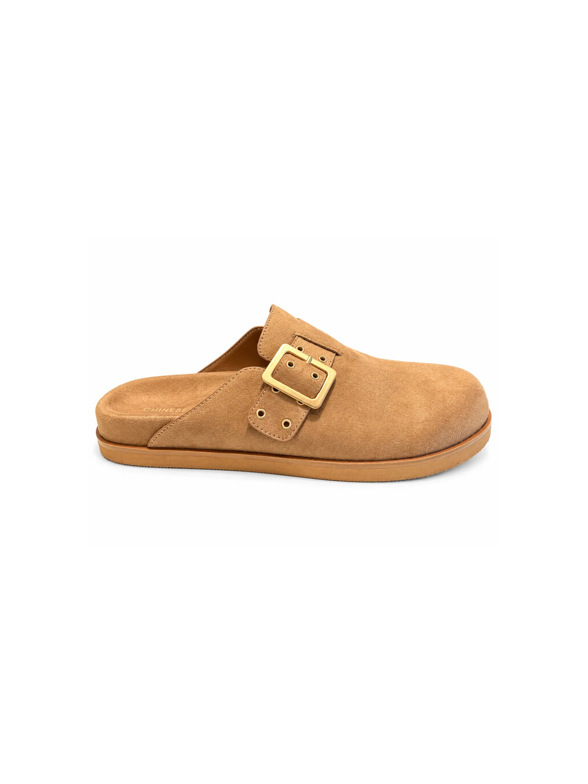 Chinese Laundry Cove suede clogs in natural tan, featuring a rounded closed toe, adjustable strap with gold buckle detailing, and a comfortable slip-on design.