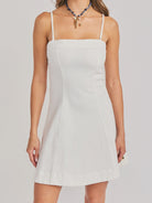 woman wearing white mini dress with spaghetti straps