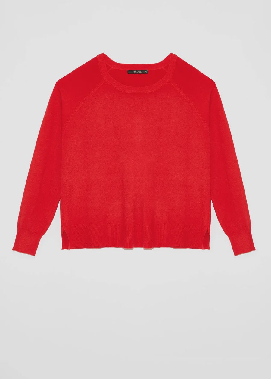 A bright red long-sleeve knit sweater with raglan sleeves.