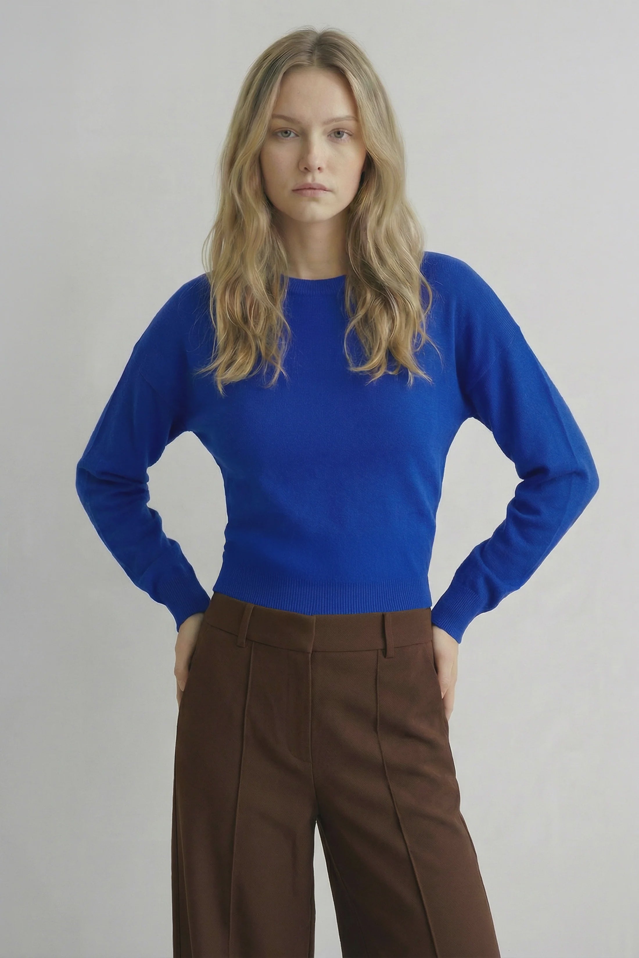 Deep blue knit sweater with a classic crew neckline and a timeless, versatile silhouette. A soft, comfortable layering essential perfect for everyday wear.
