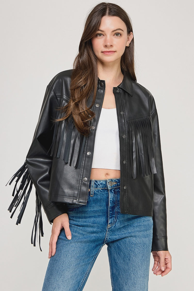 The Dakota Fringe Jacket in black faux leather, featuring bold fringe detailing and a structured silhouette with Western-inspired styling.
