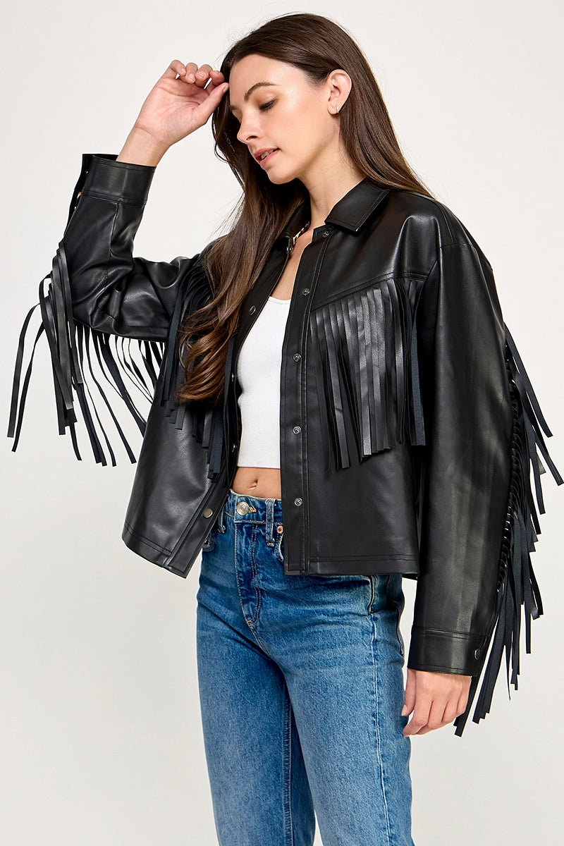 The Dakota Fringe Jacket in black faux leather, featuring bold fringe detailing and a structured silhouette with Western-inspired styling.
