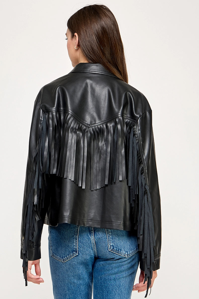 The Dakota Fringe Jacket in black faux leather, featuring bold fringe detailing and a structured silhouette with Western-inspired styling.
