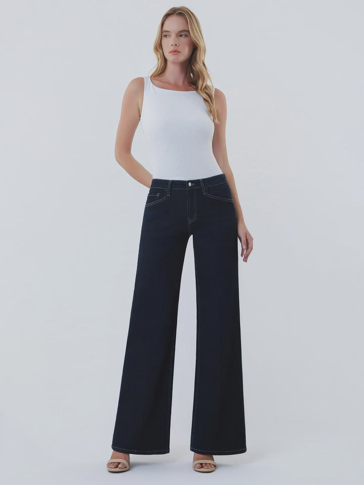 Dark wash wide-leg jeans featuring a mid-rise waist, trouser-inspired front crease, classic five-pocket design, finished hem, and full-length silhouette.