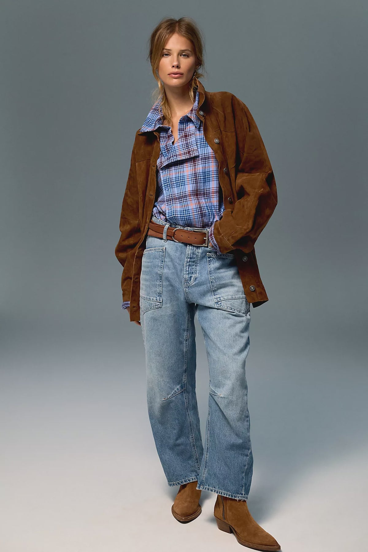 Low-rise barrel-leg pants in rigid denim with a relaxed, slouchy fit, curved leg shape, oversized patch pockets, button-fly closure, and finished hem.