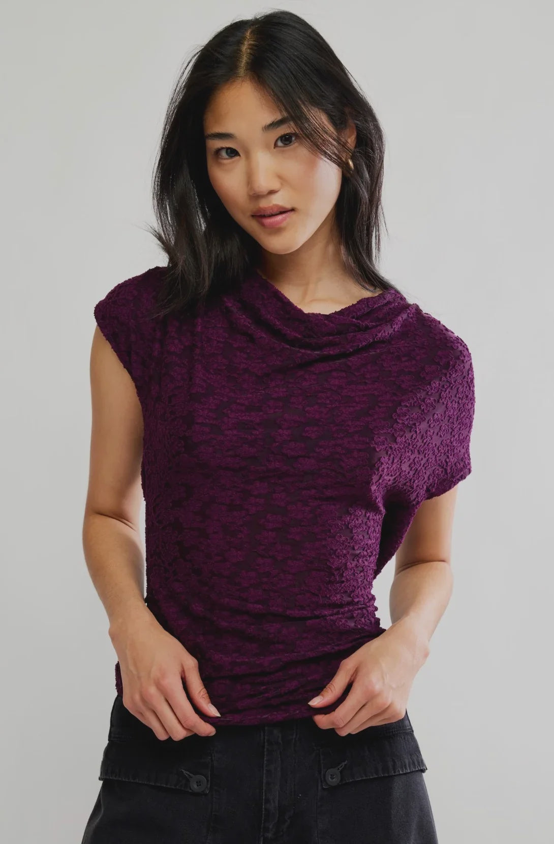 Italian plum short-sleeve top with a tonal floral texture, plunging cowl neckline, relaxed draped silhouette, and adjustable tie-back detail.
