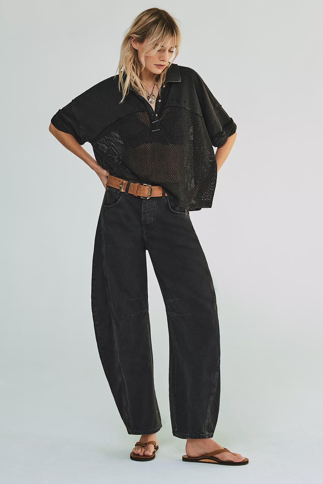 woman wearing washed black mid rise barrel jeans in an ankle length