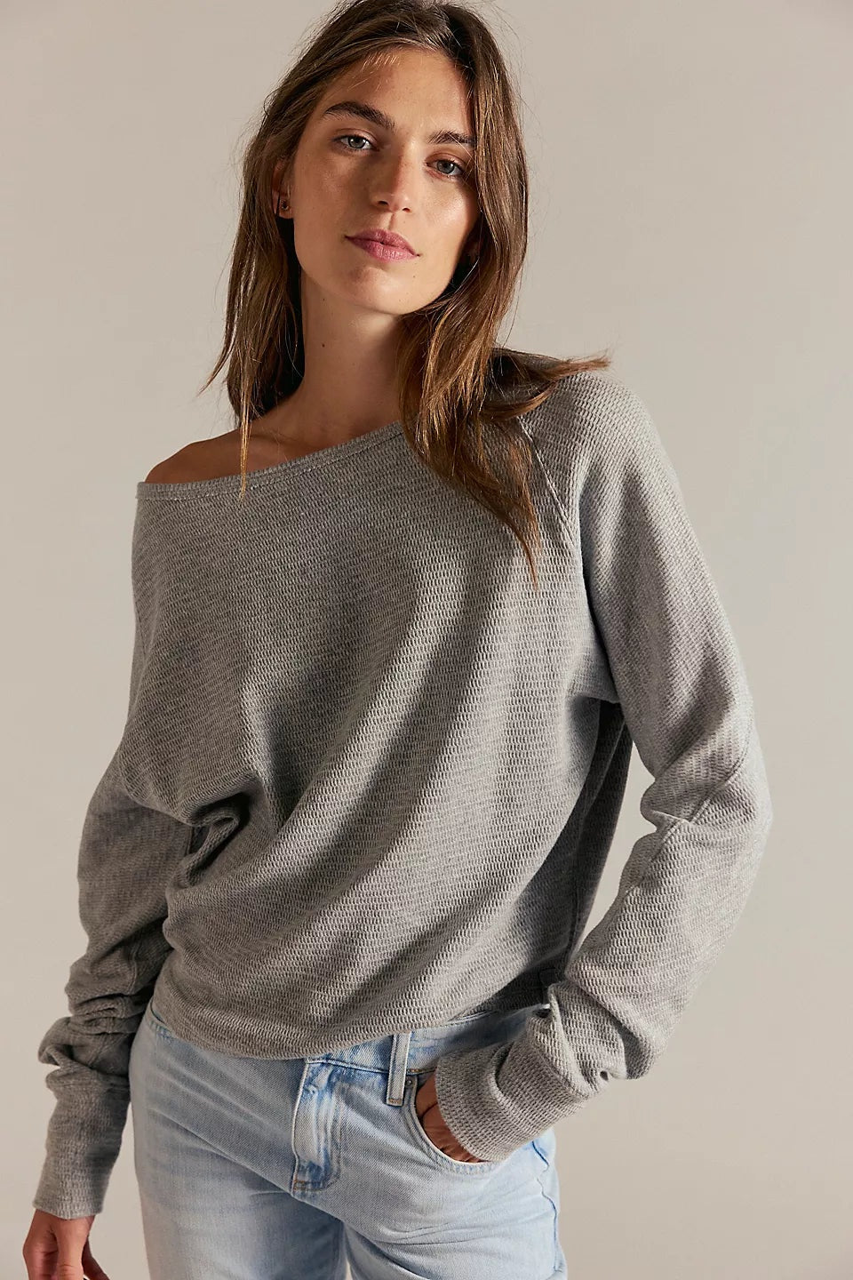 Women's textured thermal long sleeve top with a boat neckline, relaxed dolman sleeves, exposed seam detailing, and elongated cuffs. heather grey.
