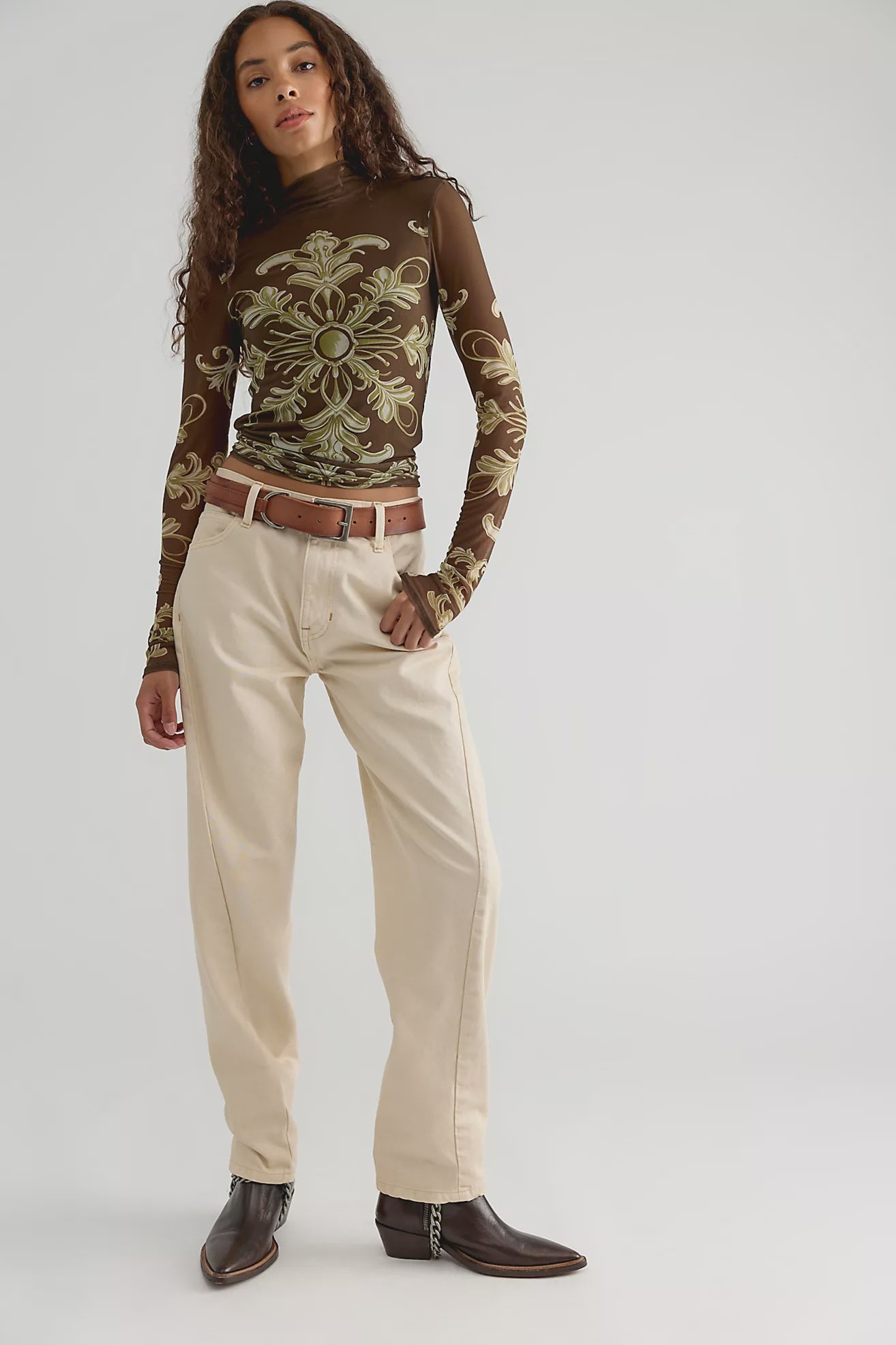 Free People Jessa Long Sleeve Top in Olive Combo featuring a fitted silhouette, semi-sheer mesh fabric, high turtleneck, long sleeves, intricate olive and cream ornamental print, and keyhole detail at the back.