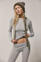 Seamless cable-knit top crafted from a soft modal blend, featuring intricate cable stitching and a flattering fitted silhouette for comfortable everyday wear and easy layering.
