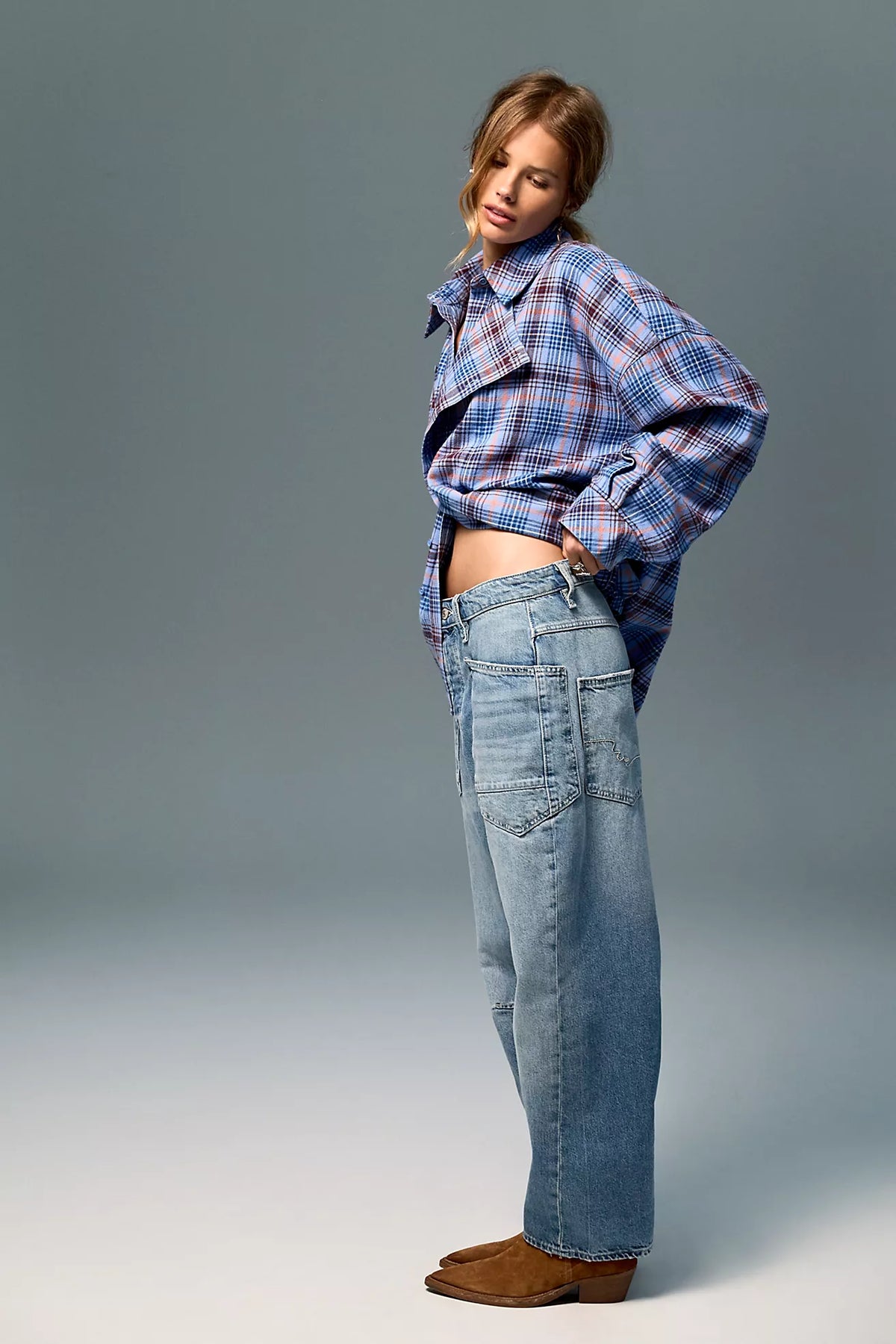 Low-rise barrel-leg pants in rigid denim with a relaxed, slouchy fit, curved leg shape, oversized patch pockets, button-fly closure, and finished hem.