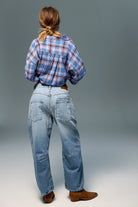 Low-rise barrel-leg pants in rigid denim with a relaxed, slouchy fit, curved leg shape, oversized patch pockets, button-fly closure, and finished hem.
