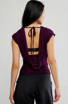 Italian plum short-sleeve top with a tonal floral texture, plunging cowl neckline, relaxed draped silhouette, and adjustable tie-back detail.