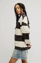 woman wearing black and white striped combo crewneck sweater