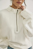 cotton ripped quarter zip sweater in clean ivory. mid length / oversized 