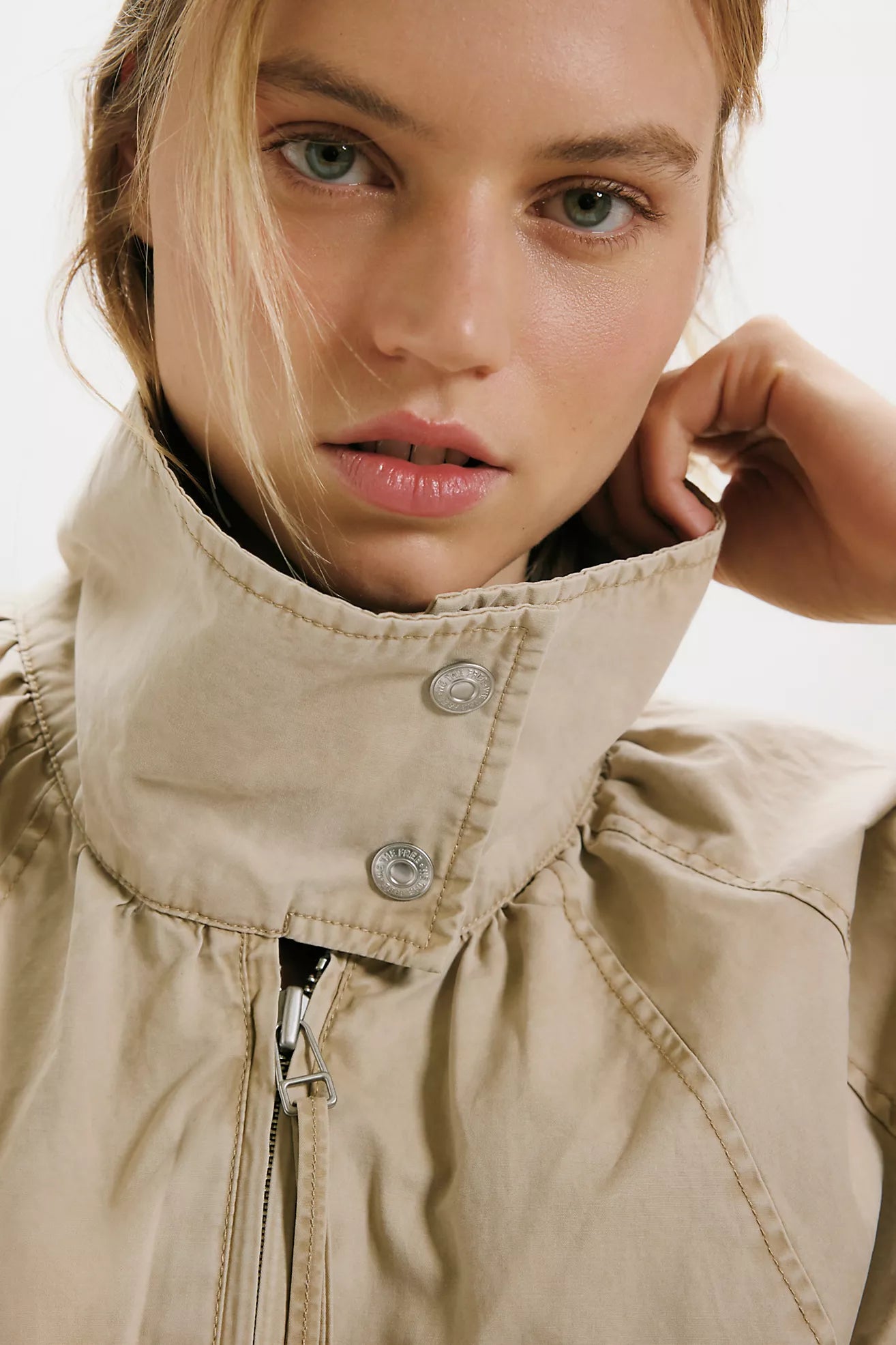 Free People Chelsea Funnel Neck Jacket in Oatmeal featuring an oversized slouchy fit, lightweight cotton-blend fabric, funnel-neck collar, raglan sleeves, adjustable drawcord waist, front zipper closure, and side slit pockets.
