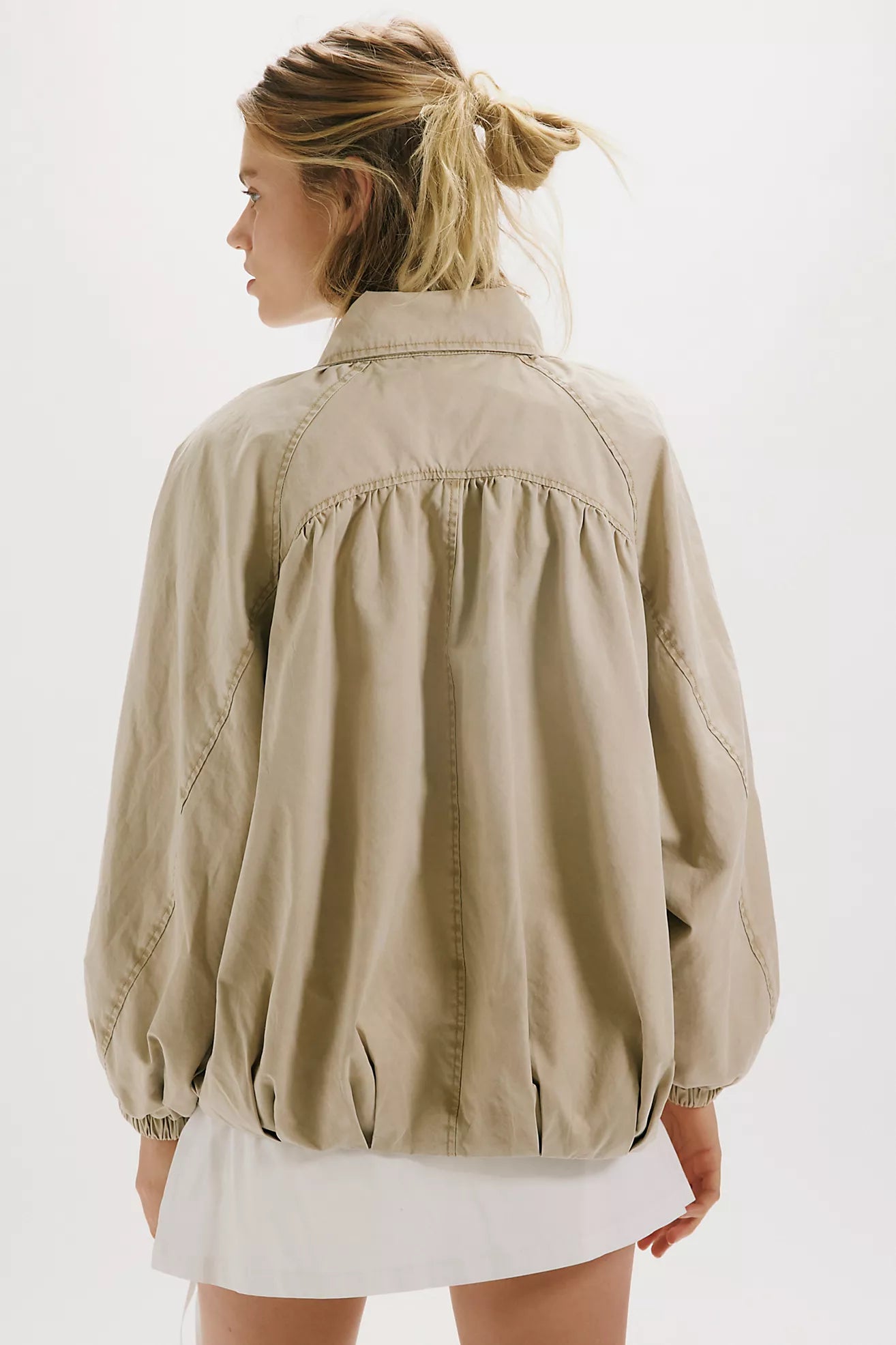 Free People Chelsea Funnel Neck Jacket in Oatmeal featuring an oversized slouchy fit, lightweight cotton-blend fabric, funnel-neck collar, raglan sleeves, adjustable drawcord waist, front zipper closure, and side slit pockets.