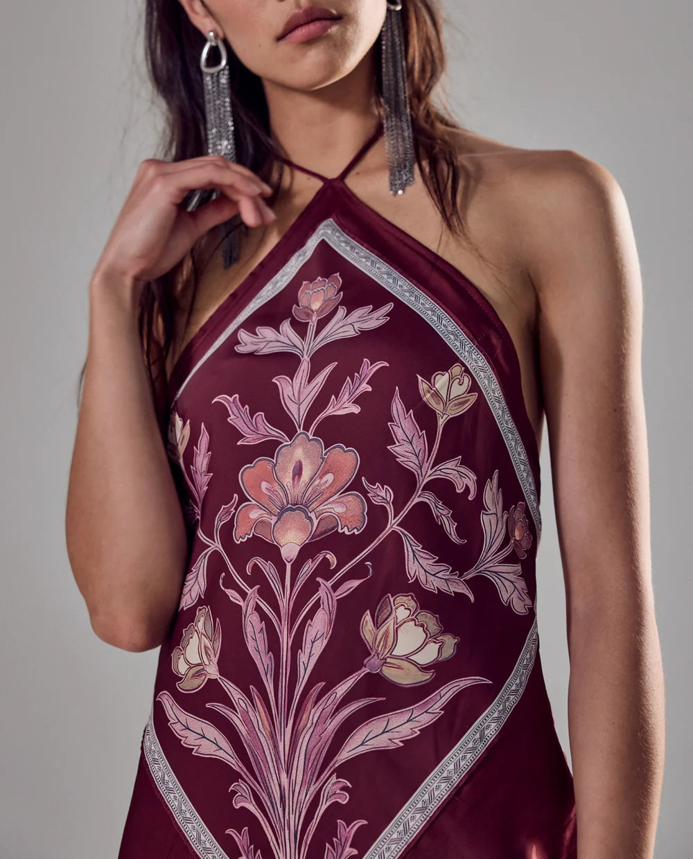 Satin midi dress with an adjustable halter neckline, fit-and-flare silhouette, handkerchief-style bodice, strapless design, and open back. Finished with a smooth satin fabrication and easy pull-on construction.