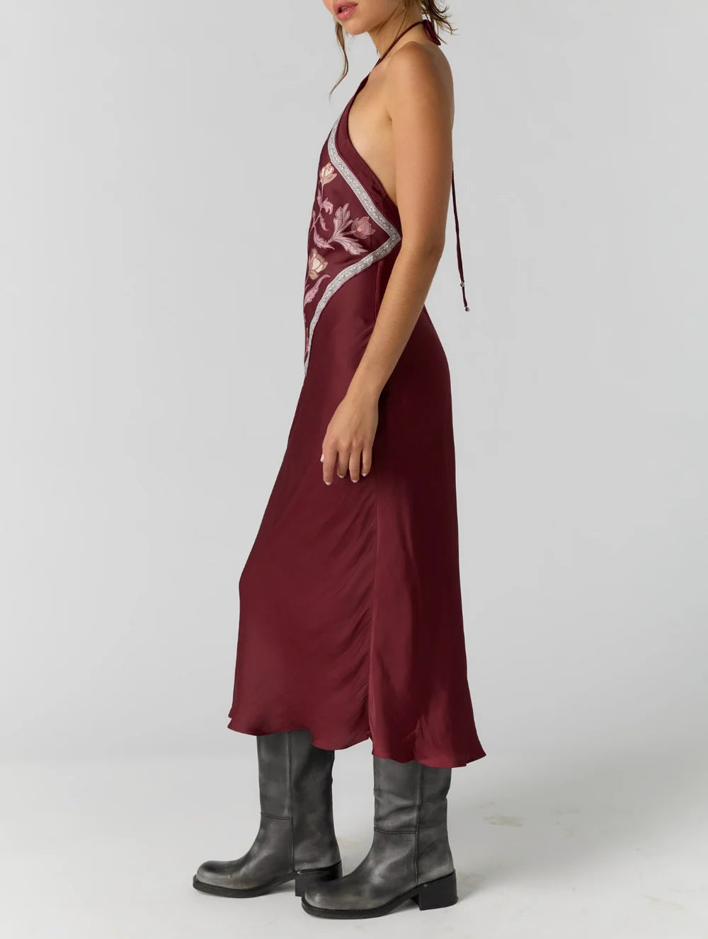 Satin midi dress with an adjustable halter neckline, fit-and-flare silhouette, handkerchief-style bodice, strapless design, and open back. Finished with a smooth satin fabrication and easy pull-on construction.