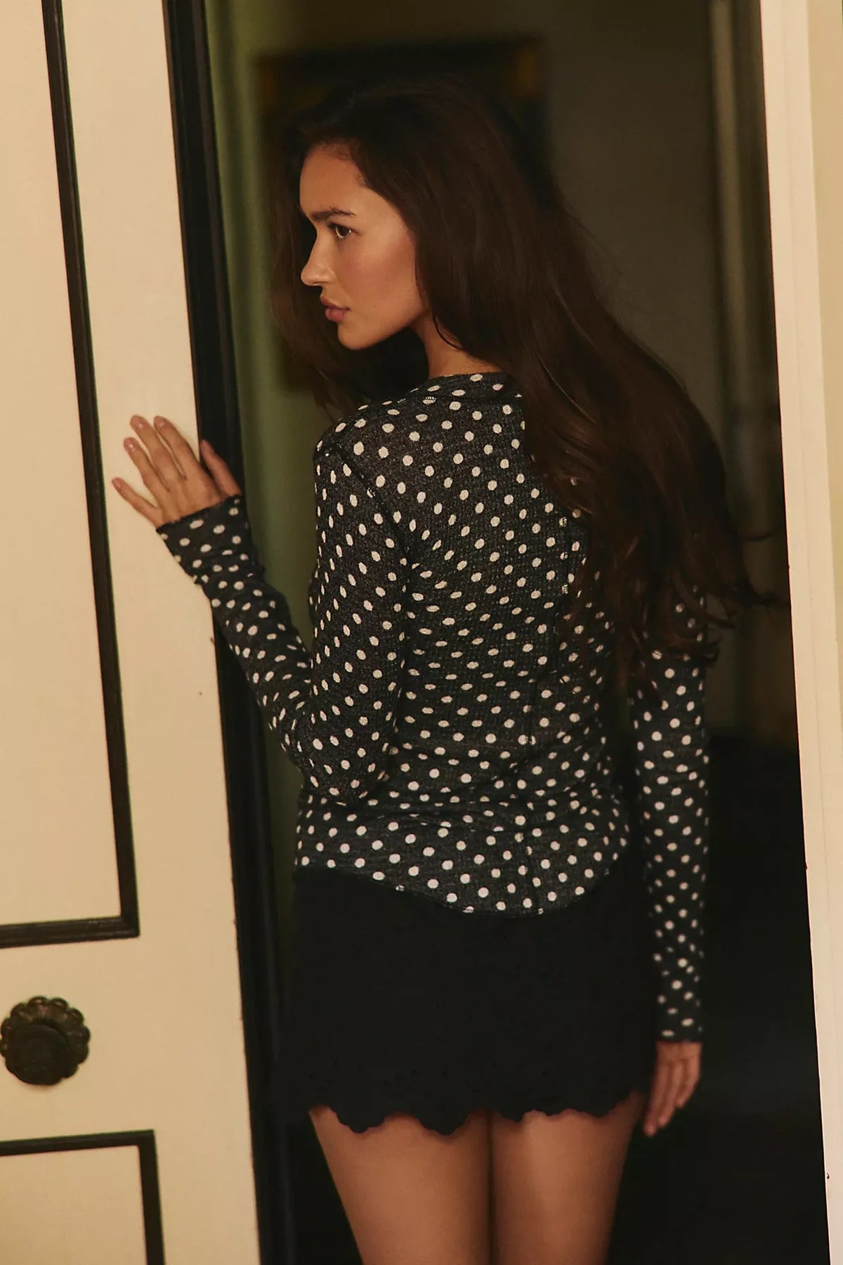 Fitted waffle-knit cardigan in a chocolate polka dot print with a crew neckline, long fitted sleeves, and snap-button front closure.