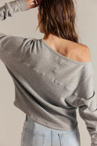Women's textured thermal long sleeve top with a boat neckline, relaxed dolman sleeves, exposed seam detailing, and elongated cuffs. heather grey.
