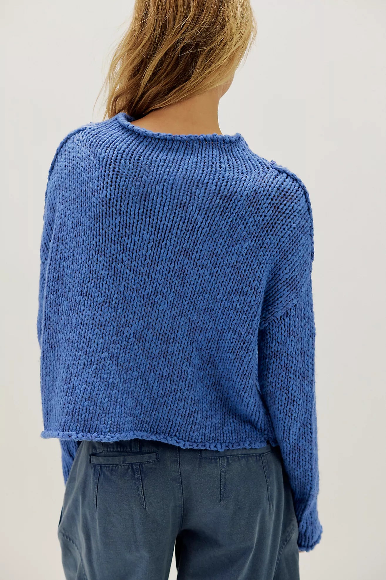 Peri Blue cotton knit sweater with a relaxed boxy fit, rolled neckline, dropped shoulders, and long sleeves.