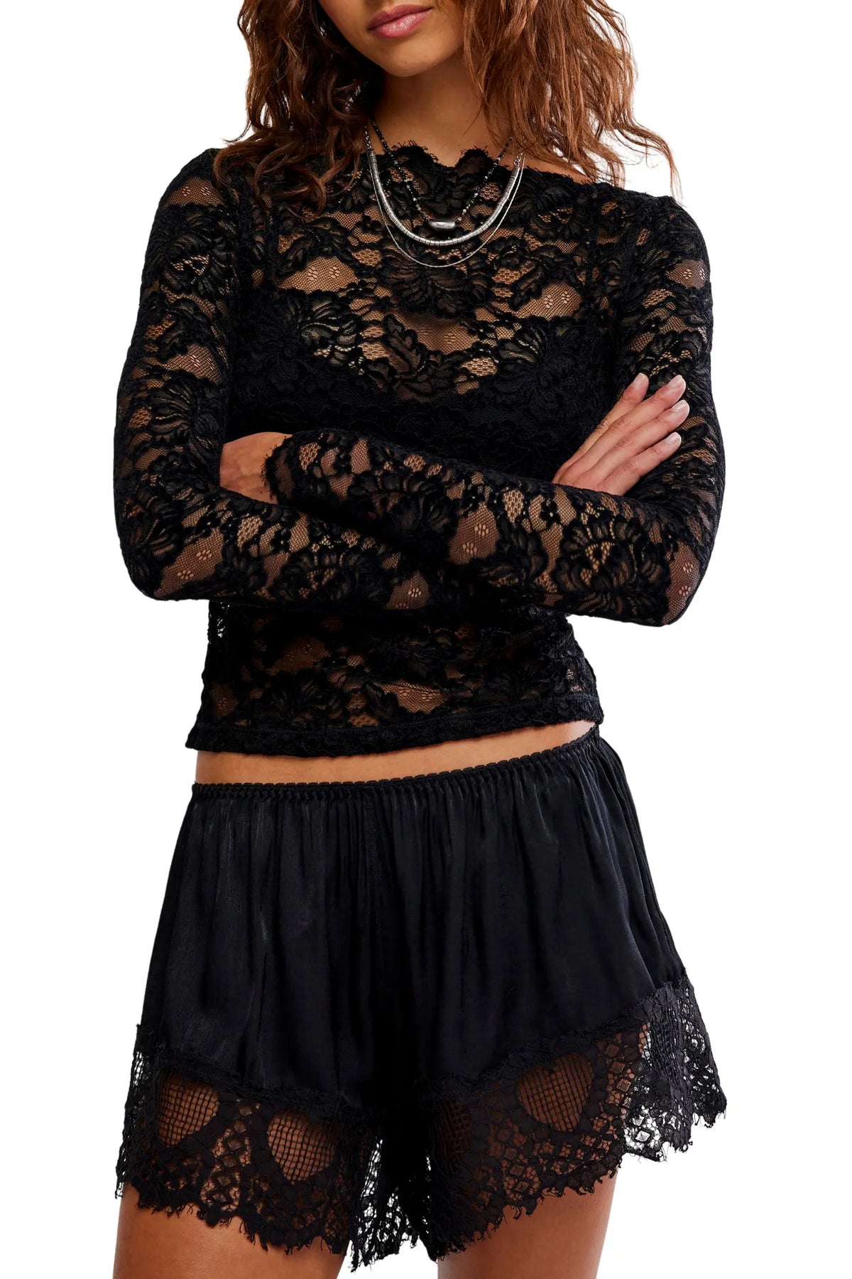 Sheer floral lace long-sleeve top with a fitted silhouette, boat neckline, ribbed trim, and added stretch for a comfortable, body-skimming fit. Base layer sold separately.