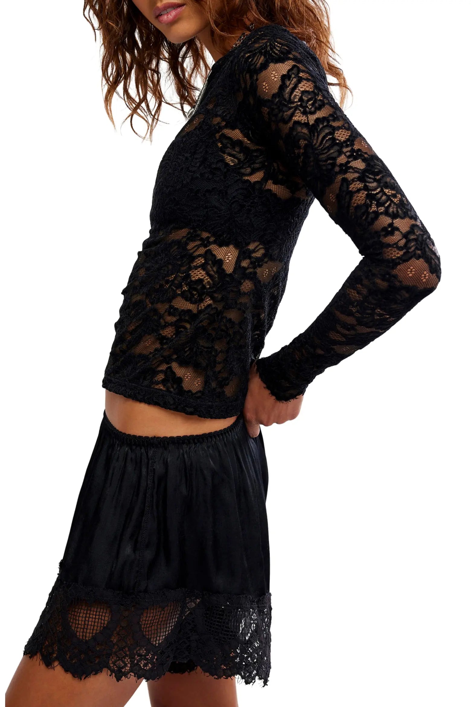 Sheer floral lace long-sleeve top with a fitted silhouette, boat neckline, ribbed trim, and added stretch for a comfortable, body-skimming fit. Base layer sold separately.