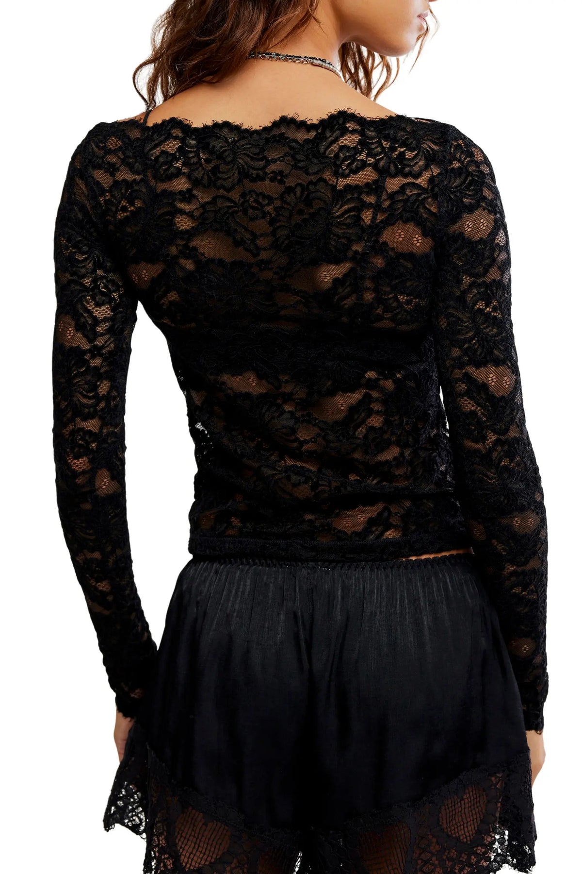 Sheer floral lace long-sleeve top with a fitted silhouette, boat neckline, ribbed trim, and added stretch for a comfortable, body-skimming fit. Base layer sold separately.