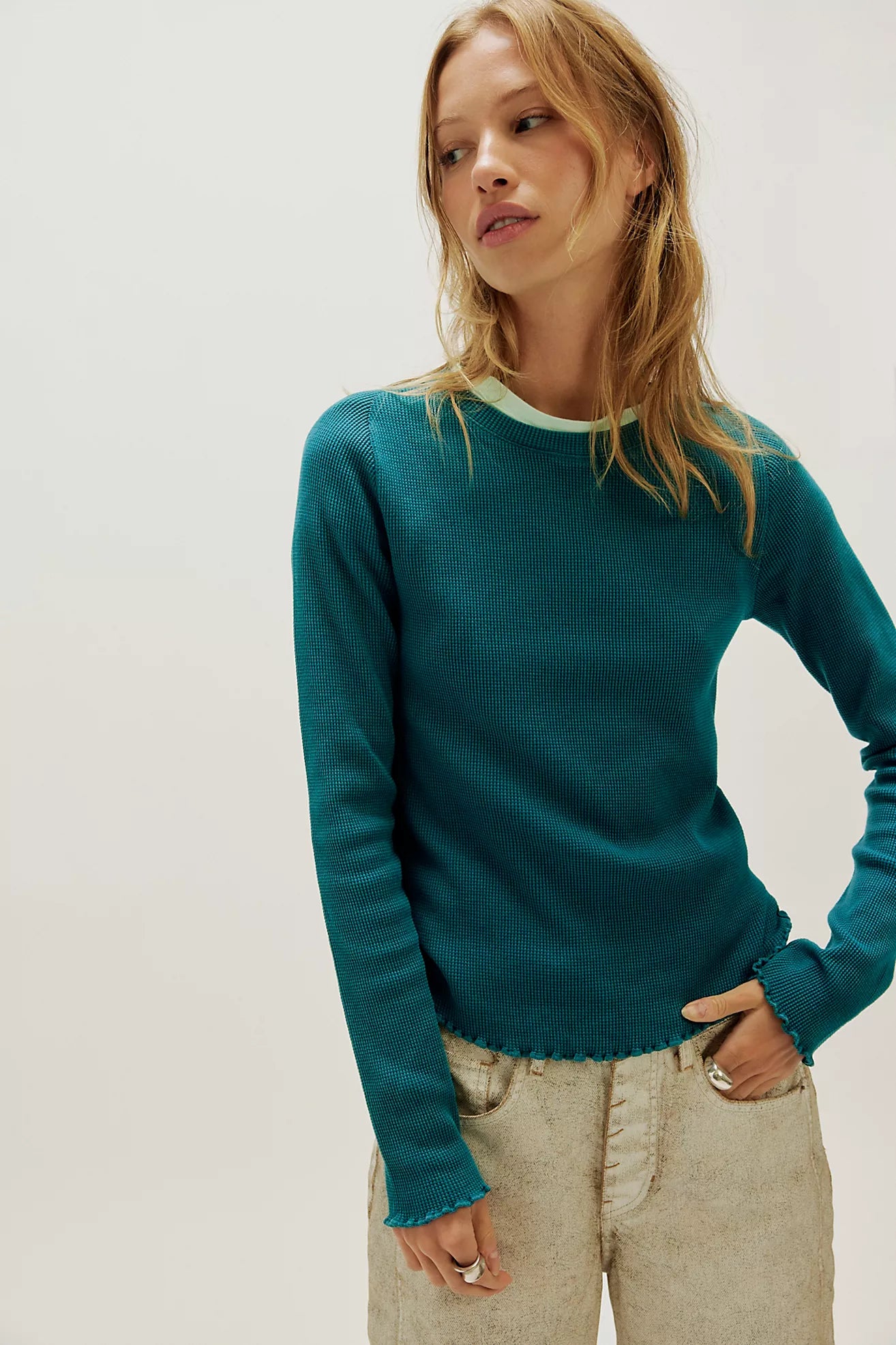 Waffle-knit long sleeve top in turqoise, featuring a relaxed slim fit, crew neckline, raglan sleeves, lettuce-edge trim, and subtle seam detailing.
