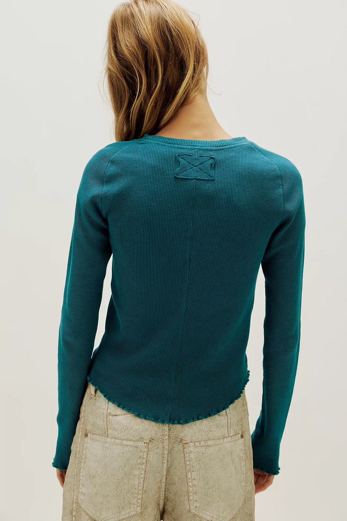 Waffle-knit long sleeve top in turqoise, featuring a relaxed slim fit, crew neckline, raglan sleeves, lettuce-edge trim, and subtle seam detailing.
