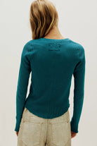 Waffle-knit long sleeve top in turqoise, featuring a relaxed slim fit, crew neckline, raglan sleeves, lettuce-edge trim, and subtle seam detailing.
