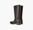 Brown Miranda 14 tall Western-inspired boots featuring a sleek vegan leather finish, square toe, 2-inch stacked block heel, and pull-on design with internal pull loops for easy wear.