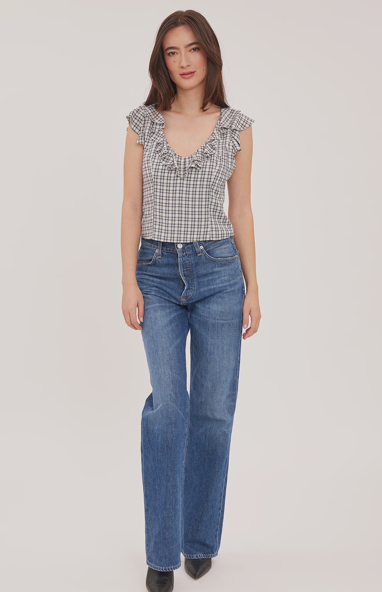 Women's black sleeveless tank top in a lightweight mini check fabric featuring a delicate flounce neckline, a relaxed fit, and a feminine silhouette.