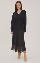 Arianna bias-cut chiffon skirt with a flattering high-rise fit, soft fluid drape, and an elastic waistband finished with delicate scalloped trim. Fully lined for comfortable wear and available in Smoke and Black.