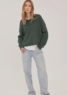 Axel oversized sweater in a soft waffle-knit yarn, featuring a crew neckline, exposed seam details, and side slits for a relaxed, textured look.