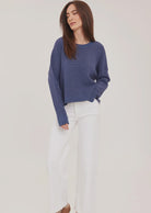 Axel oversized sweater in a soft waffle-knit yarn, featuring a crew neckline, exposed seam details, and side slits for a relaxed, textured look.