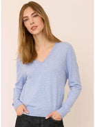 Woman wearing the Gentle Fawn Carina Sweater in Heather Blue, featuring a regular fit with a soft, lightweight knit in a classic light blue shade.