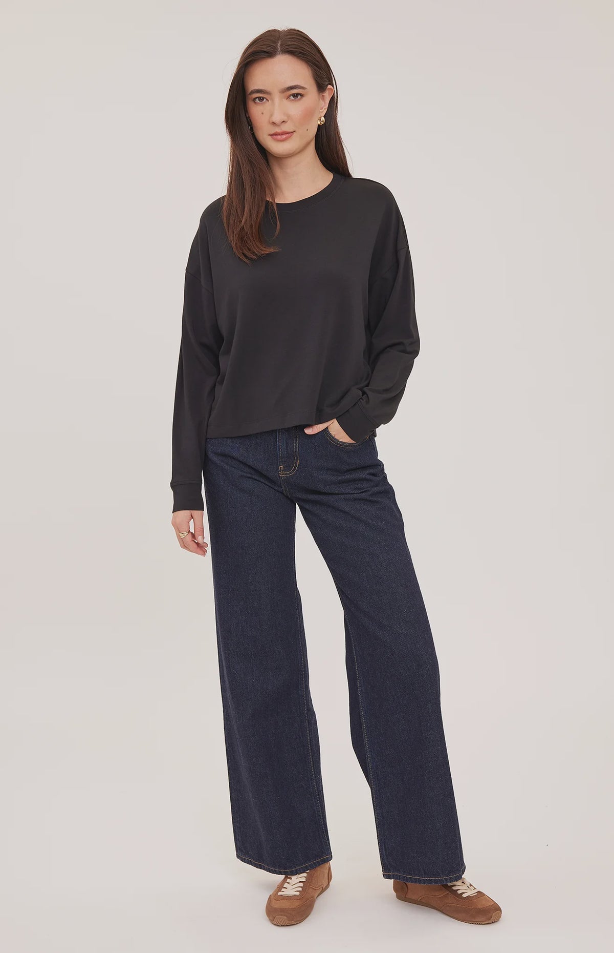 Easton top in a soft cotton-modal blend with a classic crew neckline, oversized fit, and side slit details for added movement. Available in Black and Cream.