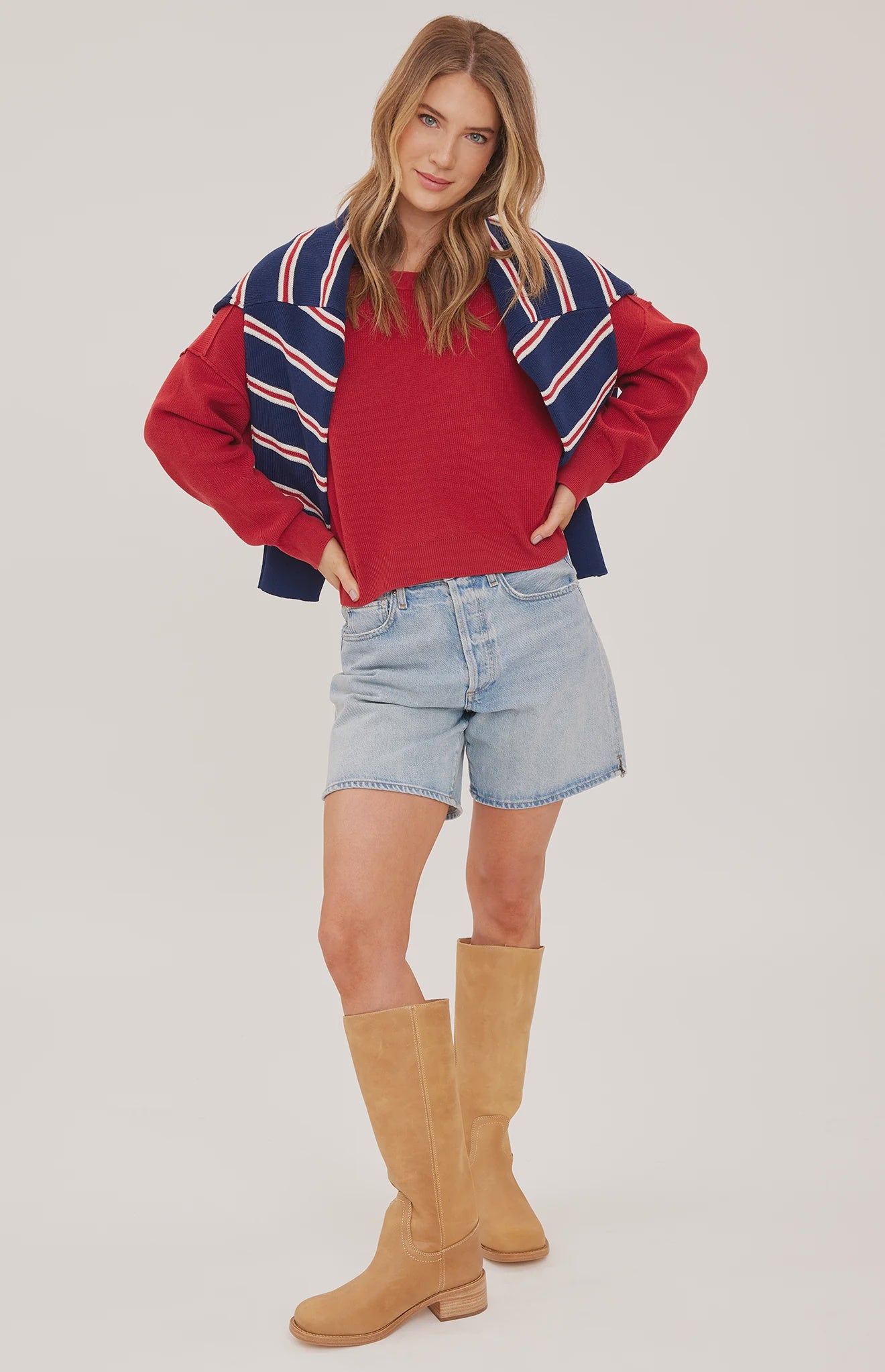 red oversized knit pullover sweater featuring a classic crew neckline, exposed seam detailing, side slits, and a soft textured half-cardigan stitch.