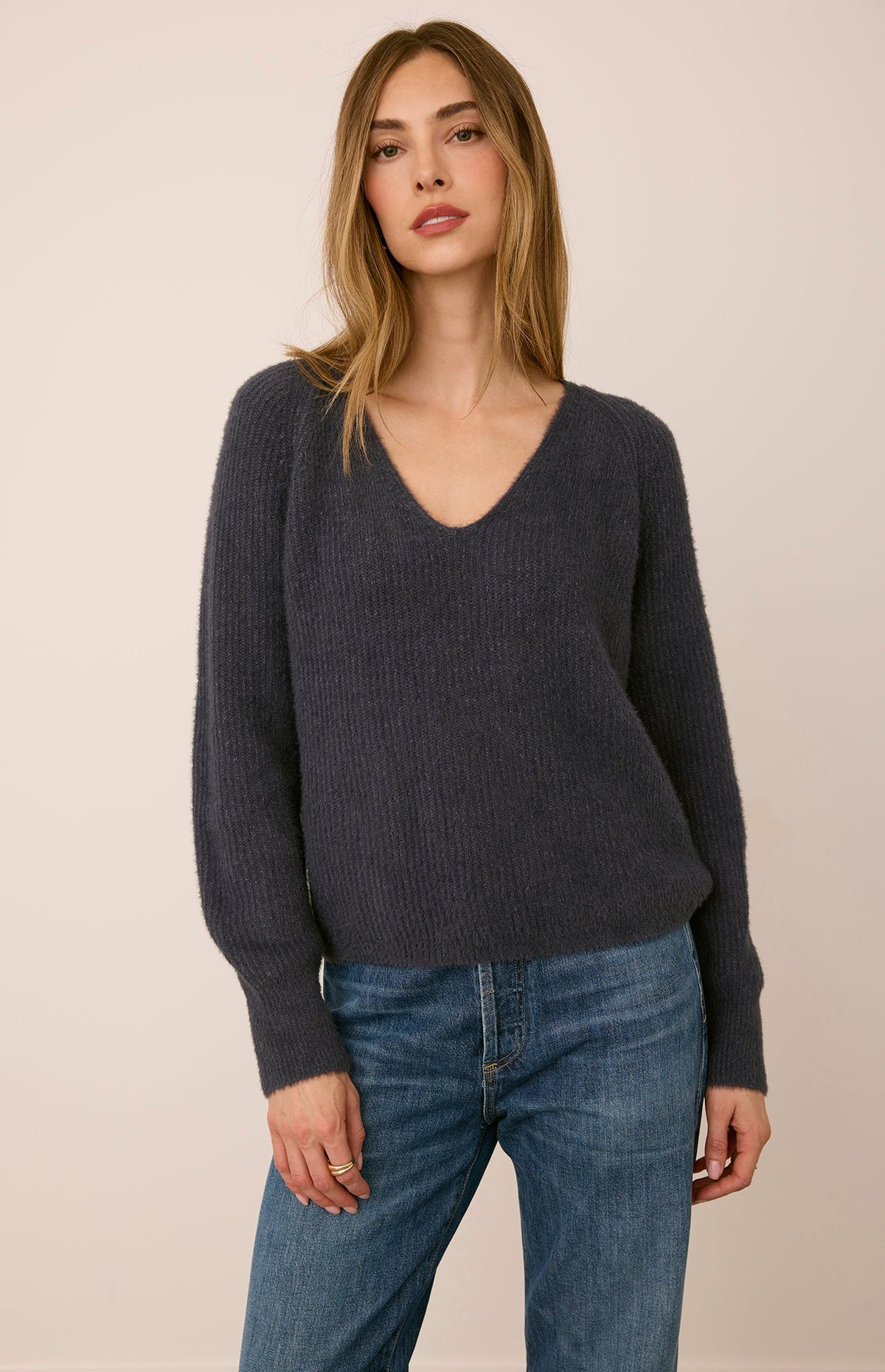 Filomena sweater in a soft, plush knit with a relaxed silhouette, flattering V-neckline, and raglan sleeves for an easy, laid-back fit. Available in Smoke and Skyline.