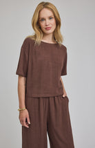 espresso coloured top in a lightweight rayon-linen blend featuring a boat neckline, side slits, and a relaxed, easy-to-style silhouette.